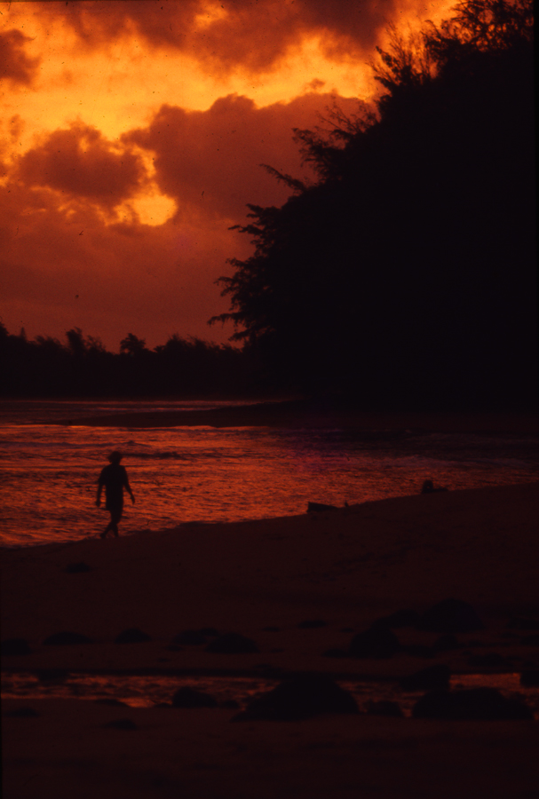 Todd walking at sunrise to Haena from Taylor Camp, north shore of Kauaʻi island in Hawaii 1974 Photo Lloyd Godman
