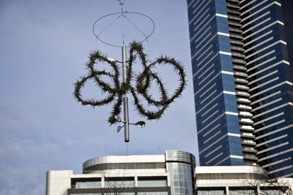 Alpha Space Station I, recycled stainless steel pipe, rice spoons, large gavanised spring, the three elements can rotate independently. Installed 27 July, 2013 - Images, with Melbourne's tallest building Eureka tower in the background.